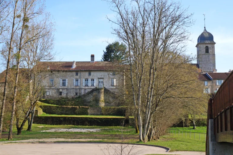 The terraced presbytery gardens with the church bell tower in the background